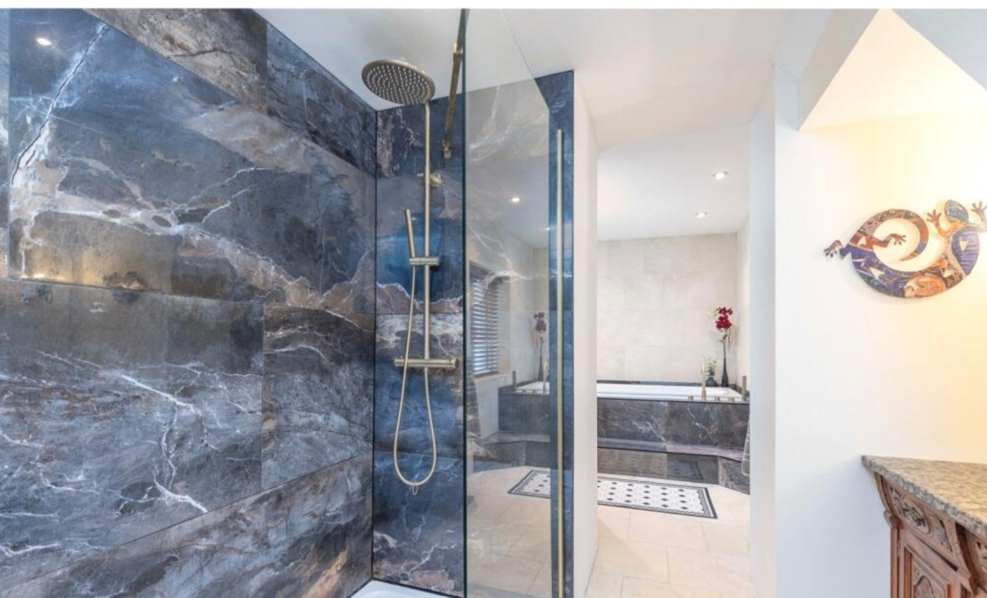 Marble-effect ensuite shower room with brass fittings in Rossendale