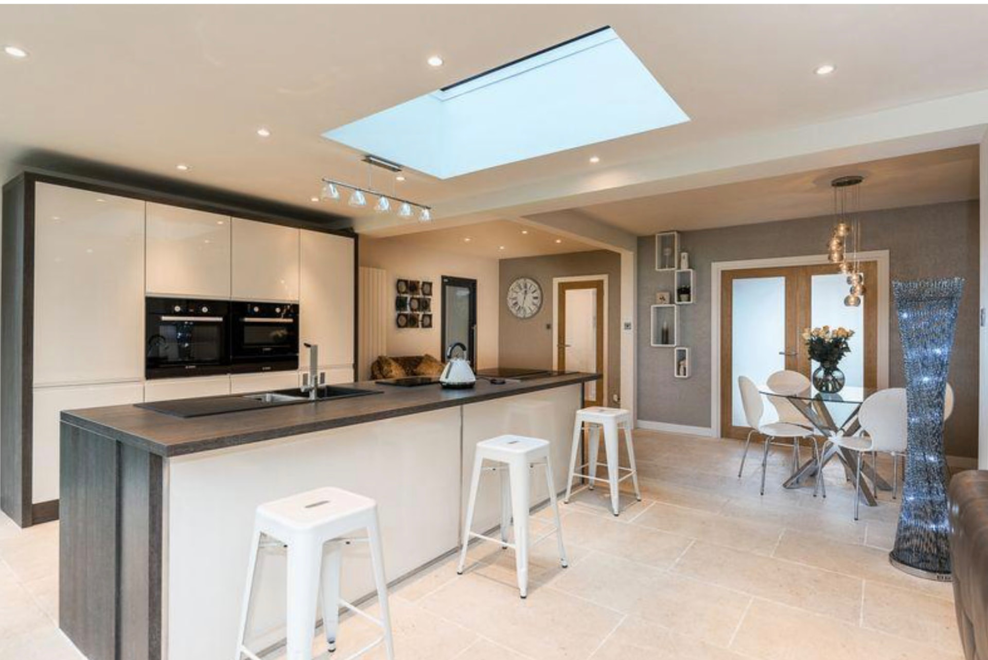 Kitchen island with rooflight above and dining area beyond