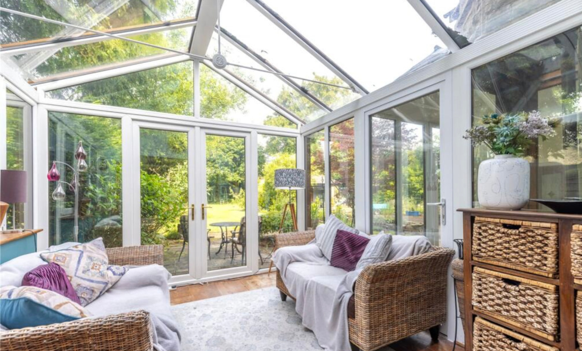 Bright conservatory interior with garden views and seating