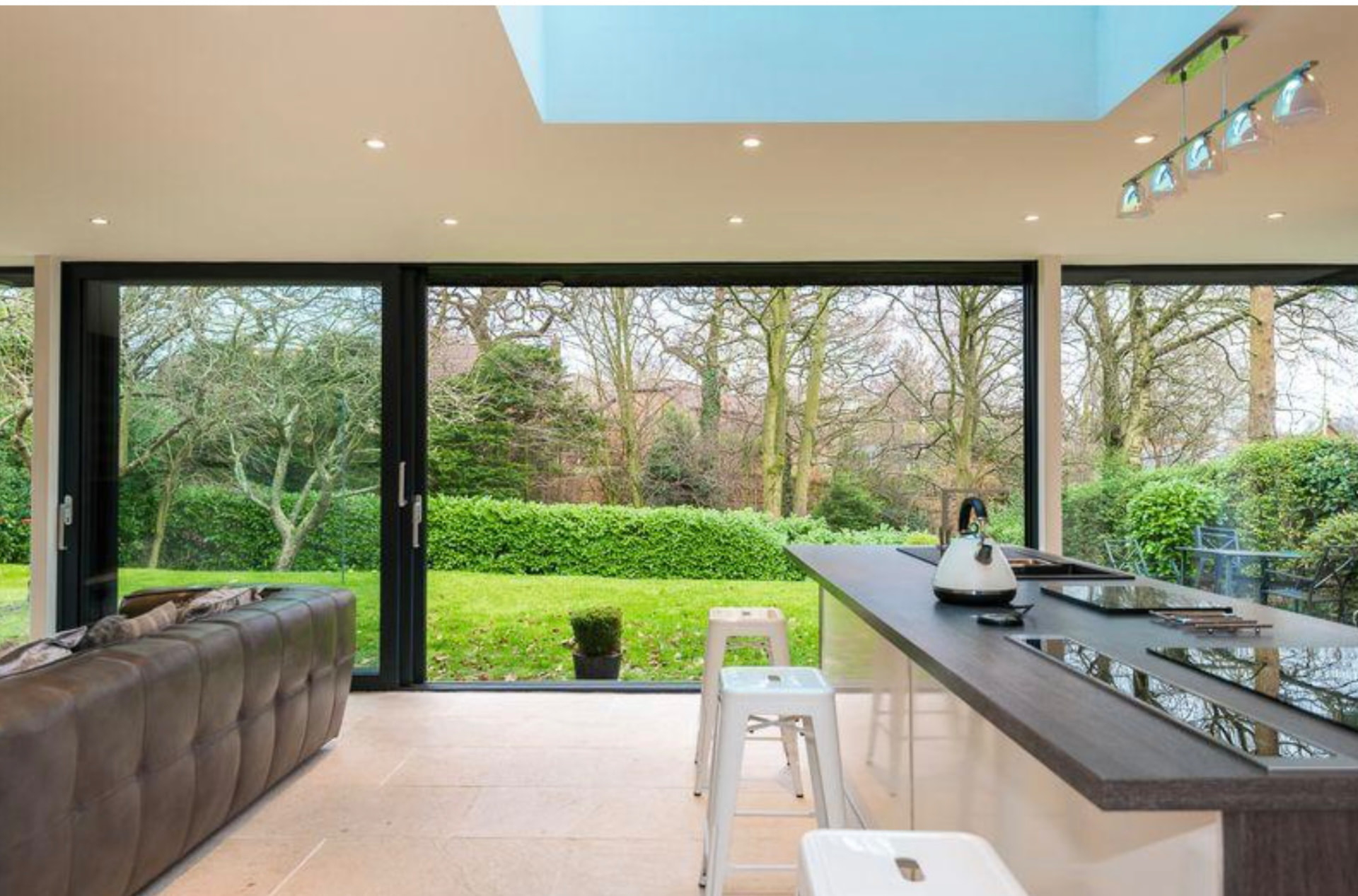Kitchen island and open sliding doors looking out over the garden