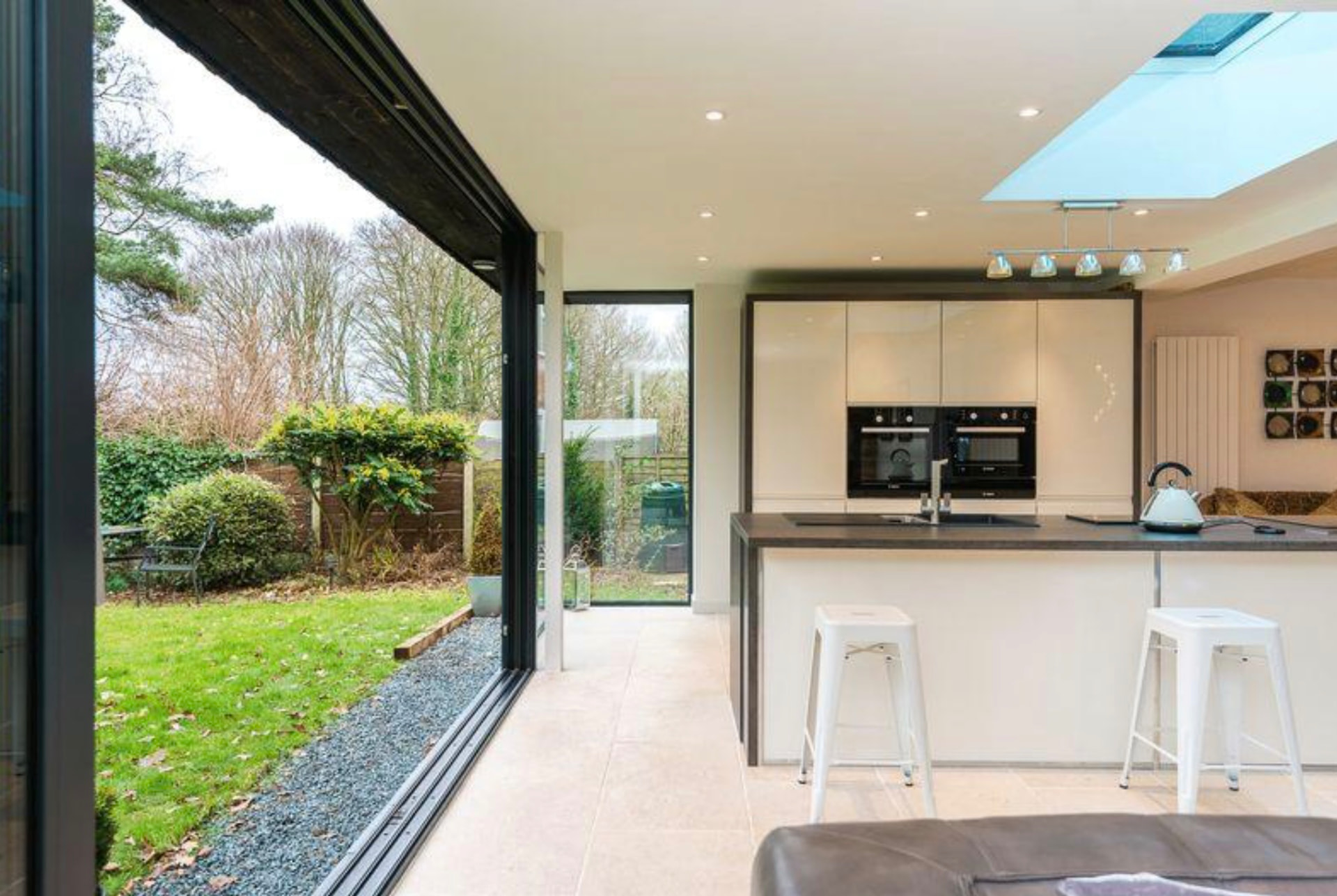 Open plan kitchen and living space with rooflight and garden access
