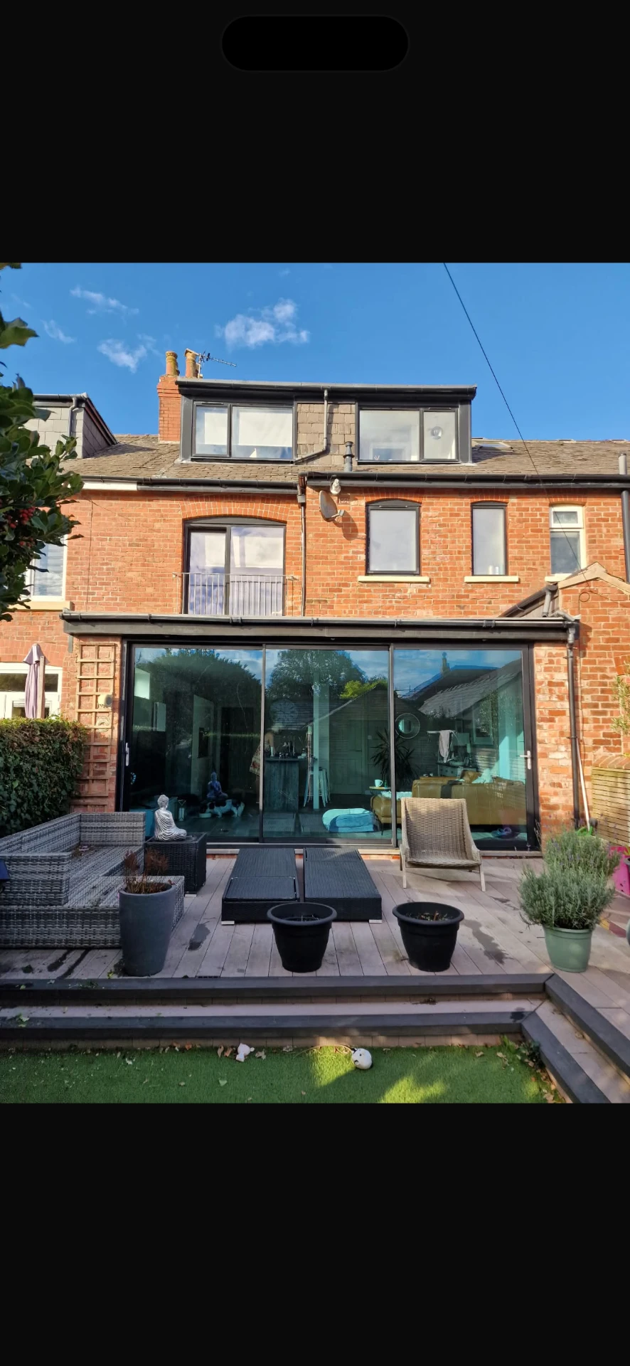 Garden view of the Lytham St Annes brick extension with wide floor-to-ceiling sliding doors